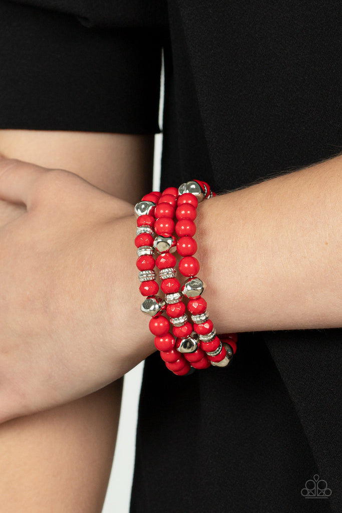 Featuring smooth, textured, and faceted finishes, a mismatched collection of fiery red and shiny silver beads are threaded along a coiled wire, creating a vivacious wire wrap bracelet around the wrist.  Sold as one individual bracelet.